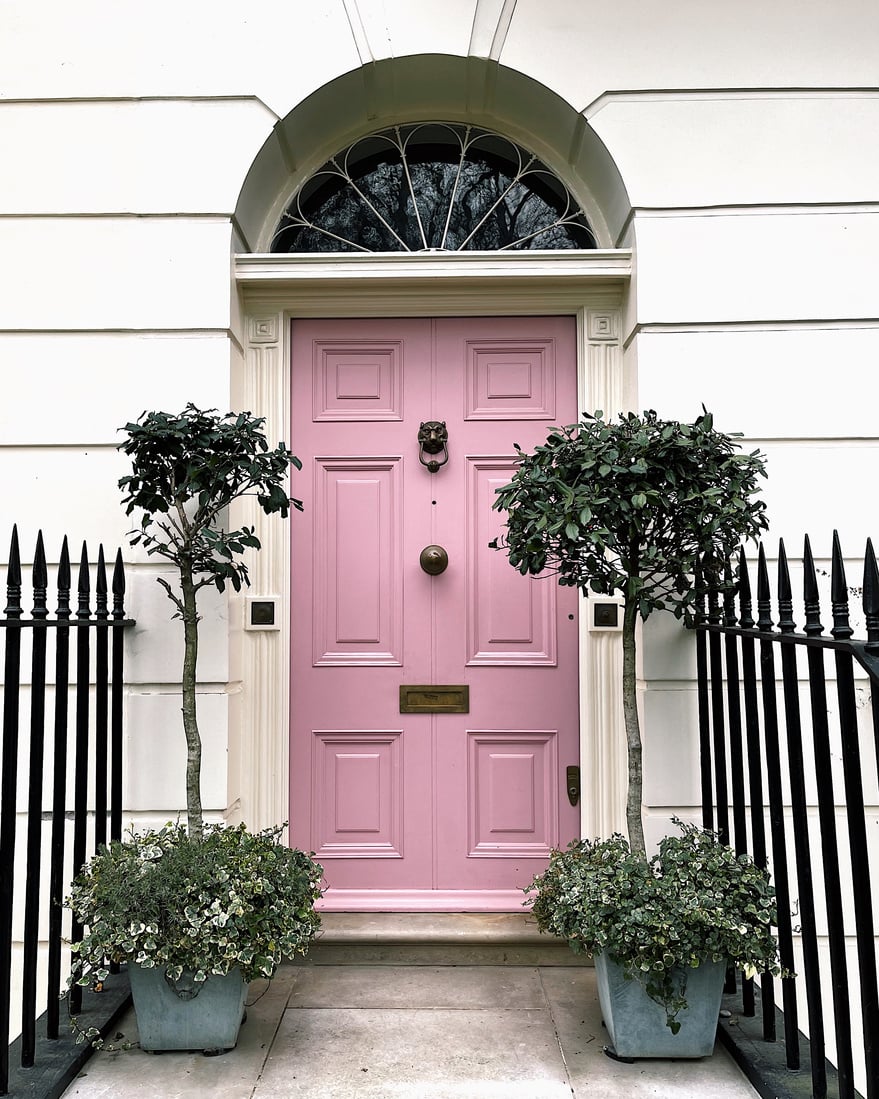 Pink entrance door in old building